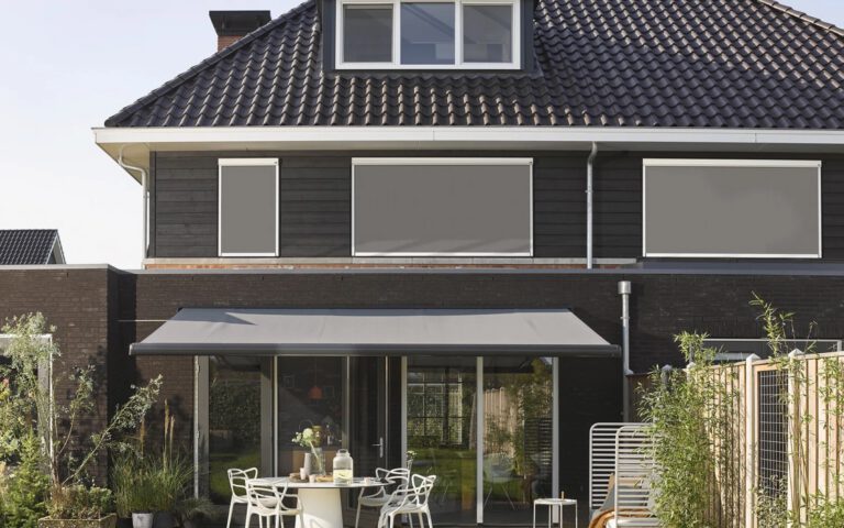 Moderne villa met knikarmscherm op het terras